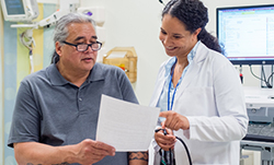 Physician and patient review a document