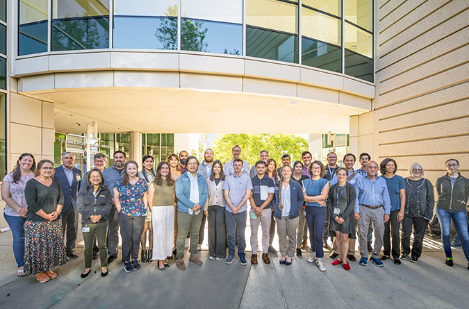 M.D./Ph.D. faculty and students standing outside the education building at UC Davis School of Medicine