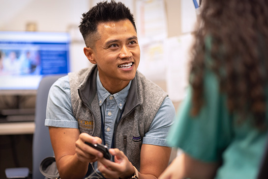 UC Davis resident in a clinical office, working on device