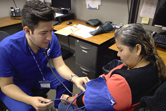 A medical student performing a patient check-up in one of the UC Davis affiliated student-run clinics