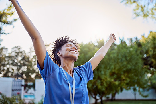 Health professional stretching their arms skyward