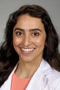 Portrait of medical student Maité Garcia in white coat and smiling