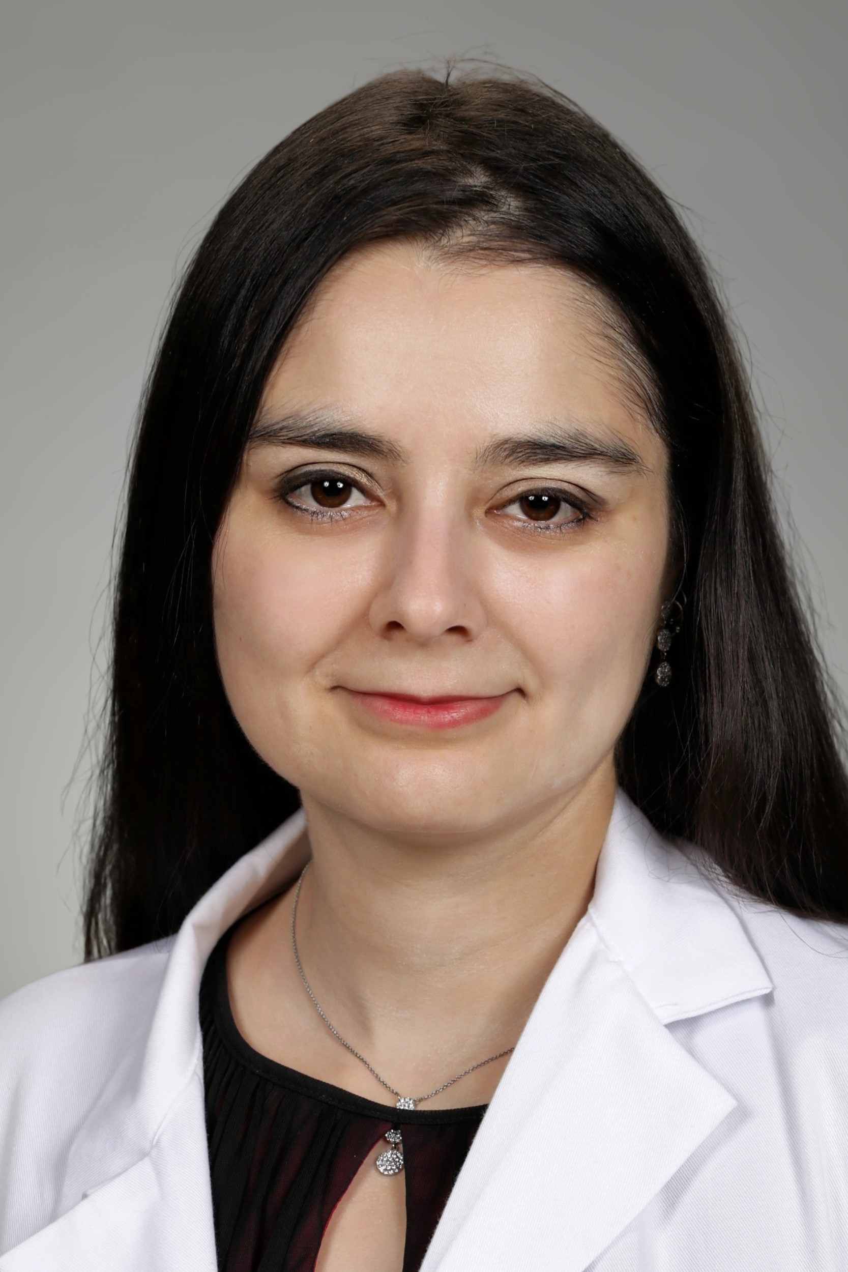 Portrait of medical student Miriam Gonzalez in white coat and smiling