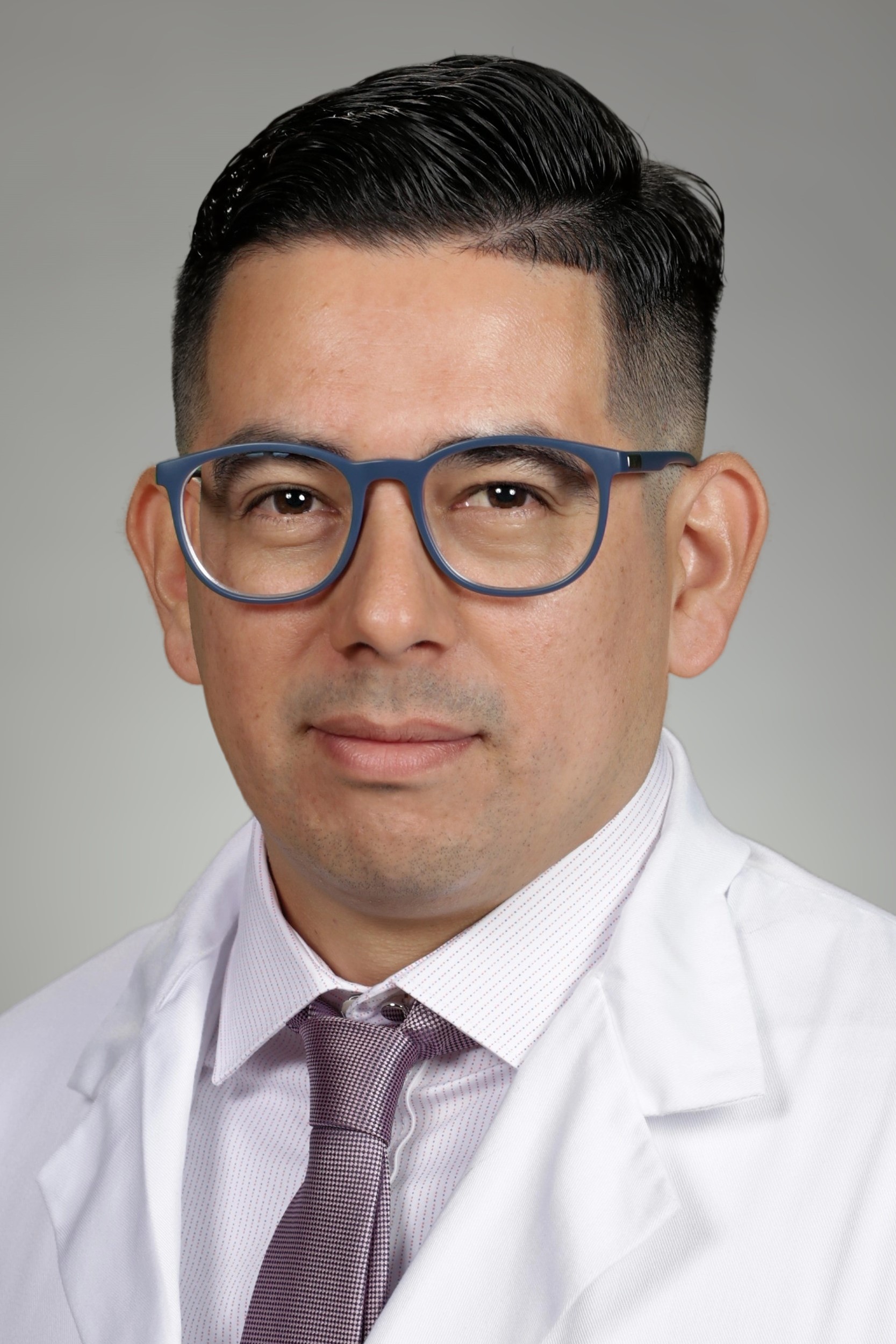 Portrait of medical student Michael Guzman Hernandez in white coat