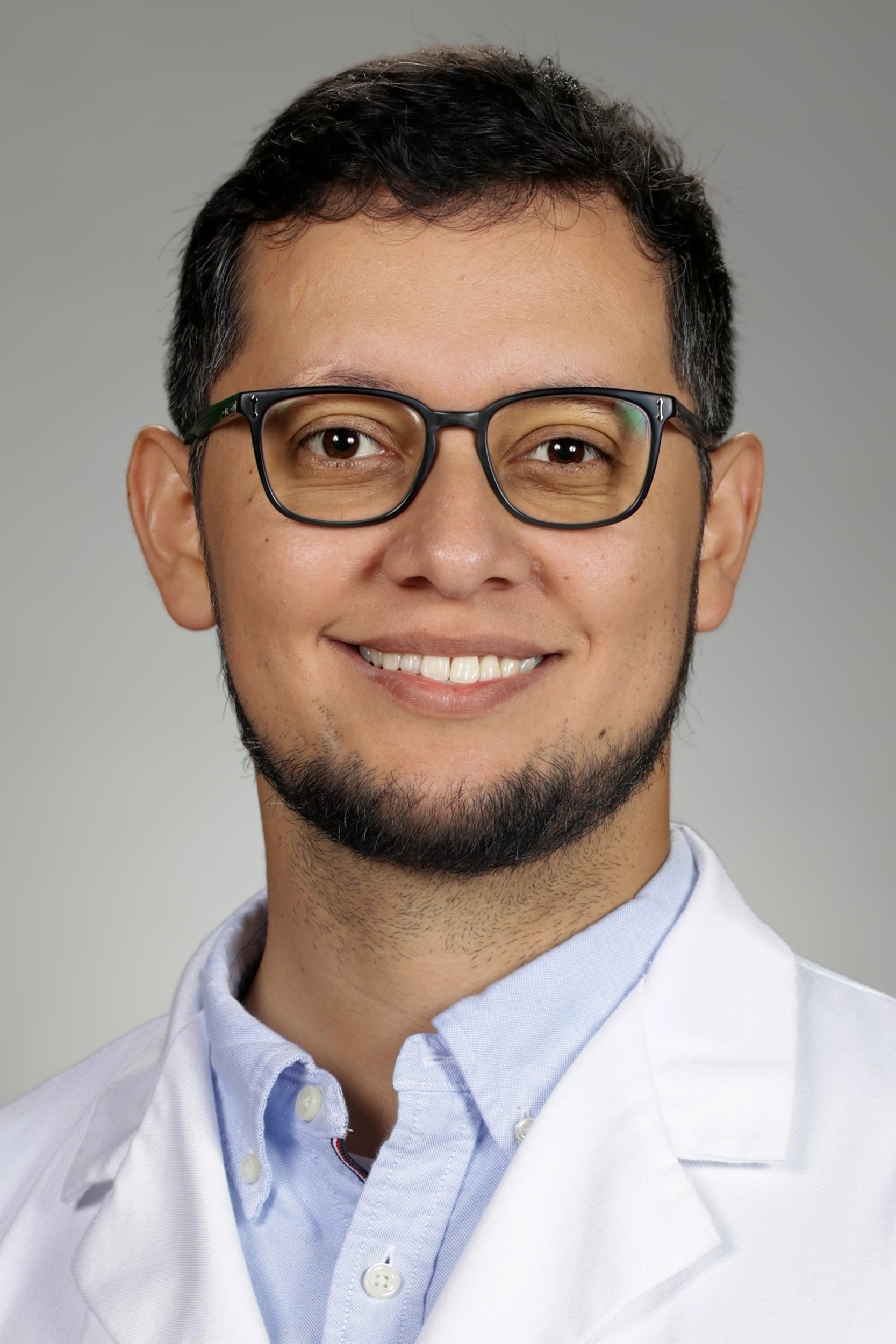 Portrait of medical student Ruben Ramirez Martinez in white coat and smiling