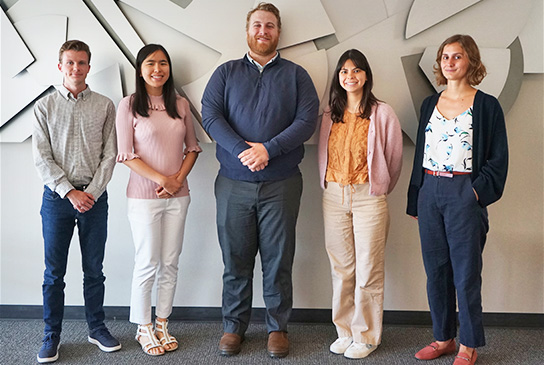 Joseph Morrison, center, with other MD/PhD students in 2024 cohort