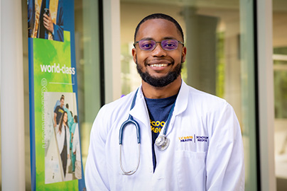 UC Davis medical student standing outside of education building