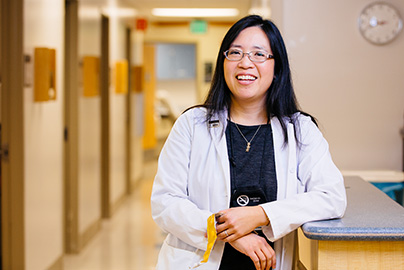 PI investigator Elisa Tong talking with a staff person in hospital hallway