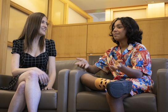 child talking with researcher in the clinic