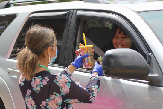 mind staff handing out donations to families