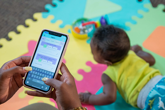 parent holding phone using application