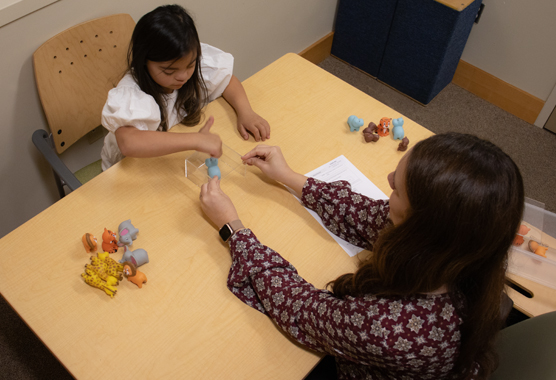 child working with a researcher