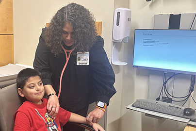 Genetic doctor checks genomic child's heart and pulse.