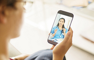 A health provider appears on a patient's smartphone screen during a video visit
