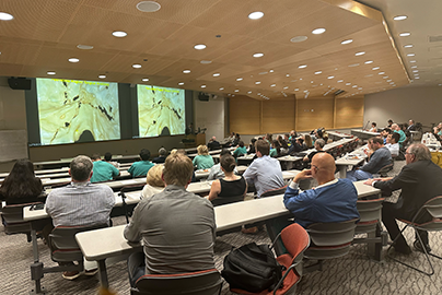 people attending a lecture presentation in a lecture hall
