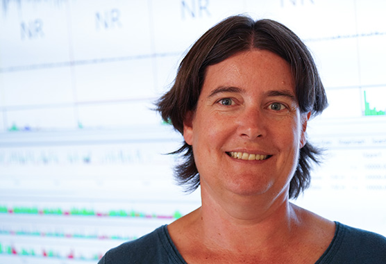 Christelle Anaclet in front of EEG