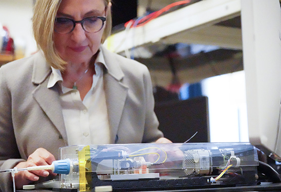 researcher studying a contraption