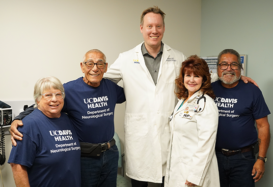 Ben Waldau, M.D. smiling with patient and family
