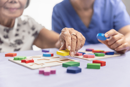 Elderly playing with puzzles