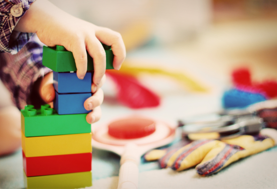 Children hands playing with building blocks