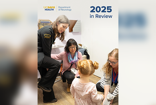 Women smiling and playing with a little girl with pigtails