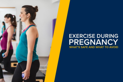 A pregnant woman with lunges forward with small weights in a group exercise class.