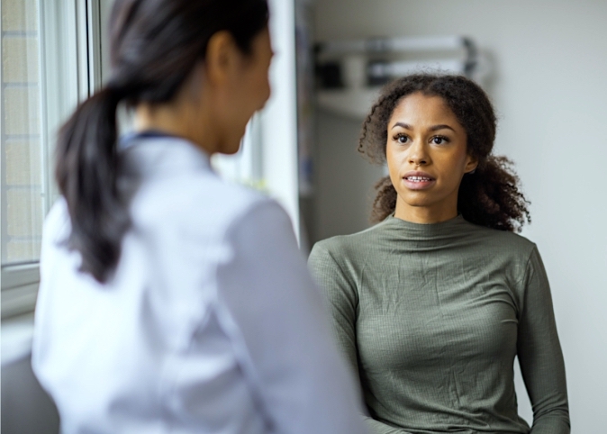 man and woman sitting together looking at ultrasound photo