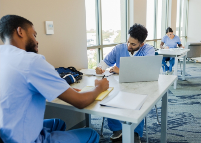 med students studying in a library