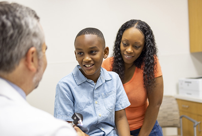 Doctor and pediatric patient with his mother 