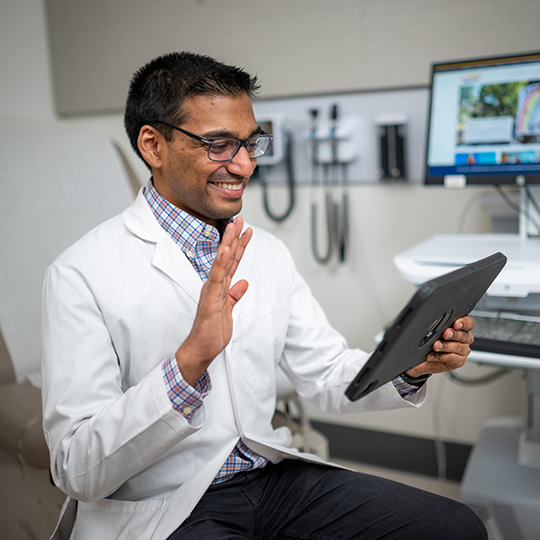Doctor using an iPad during a video visit appointment