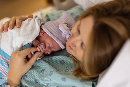 Emily and her newborn Beatrice in the hospital