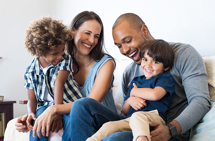 Happy, mixed race family at home