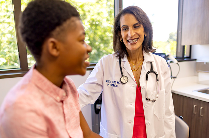 UC Davis doctor providing check-up for young boy