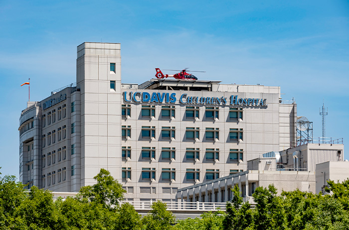 UC Davis Children's Hospital with red transport helicopter on top of the building