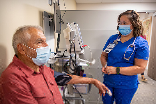 Elderly man getting a check-up from UC Davis nurse