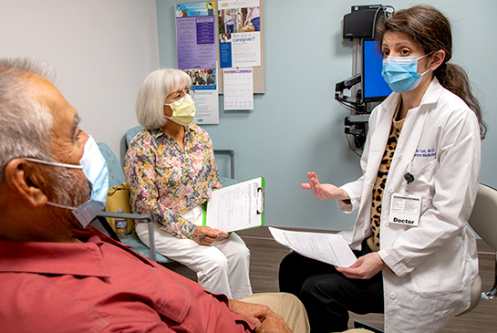 Docter with elderly couple in clinic