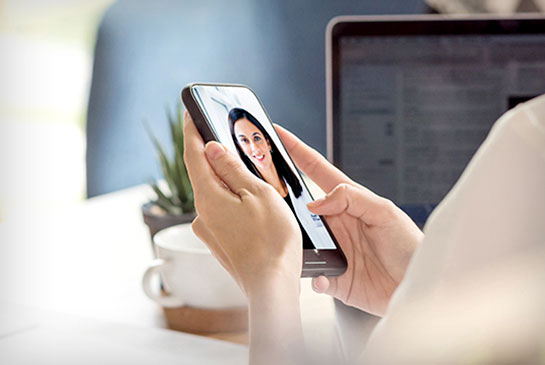 patient holding mobile phone to talk with doctor