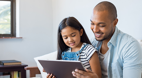 Father and daughter using a tablet