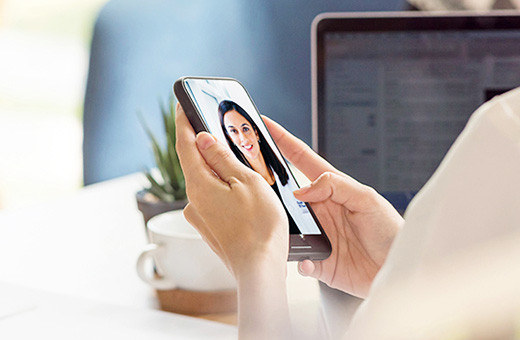 Patient using phone to have a video visit with her UC Davis doctor