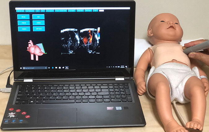POCUS Training using laptop connected to baby doll that has sensors in it for POCUS detection/scans