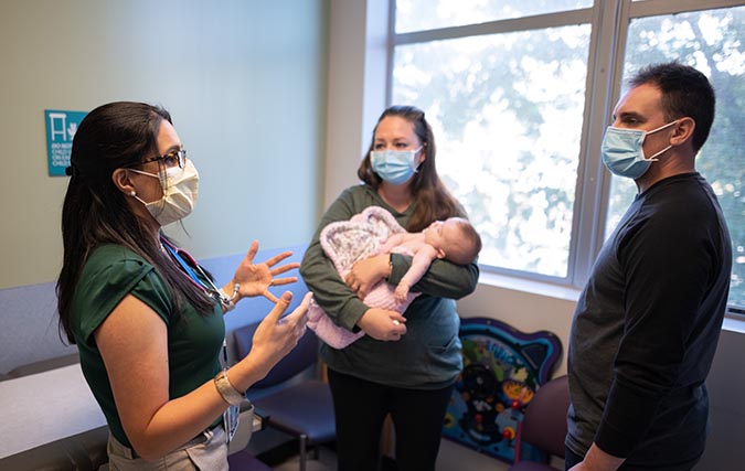 Dr. Sunderji consults with pediatric patient's parents.