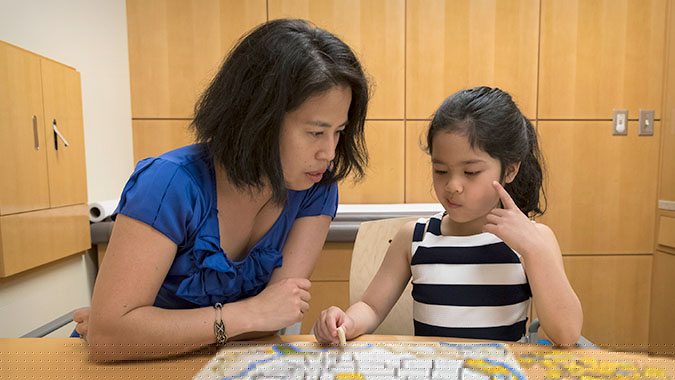 Dr. Angkustsiri with patient at MIND Institute