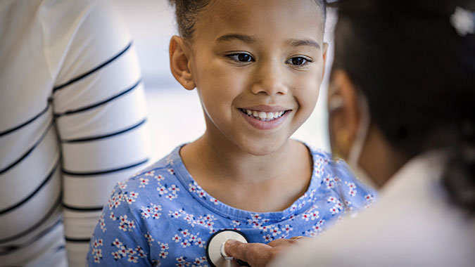 Young patient getting check-up from a resident, stock image
