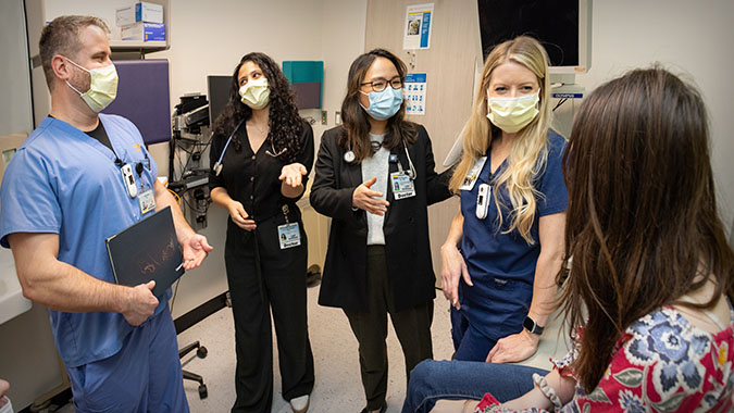 pediatric pulmonology team with patient in clinic room