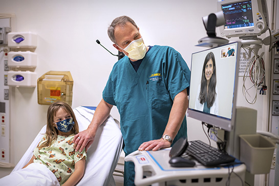 Dr. Marcin in a telemedicine consult with a pediatric patient and another pediatrician.