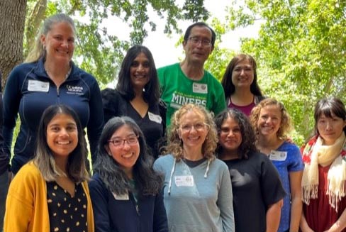 Genomic Medicine team poses outdoors at casual event.