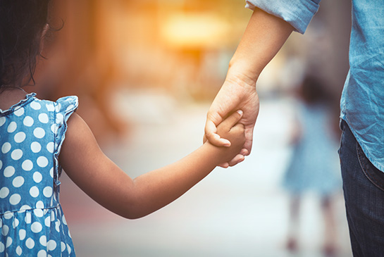 Dad holding hand of child