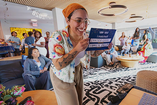Potential Resident looks at match announcement at match day party