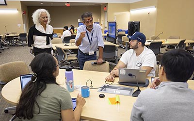 Senior faculty teach residents in conference setting