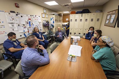 Small meeting with clinicians in staff lounge.